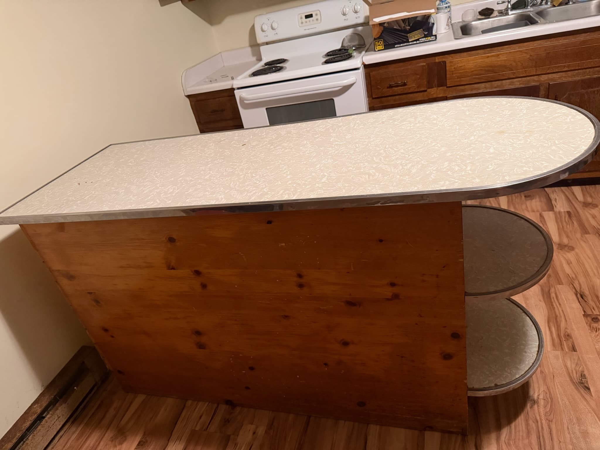 Worn kitchen peninsula with an old laminate countertop