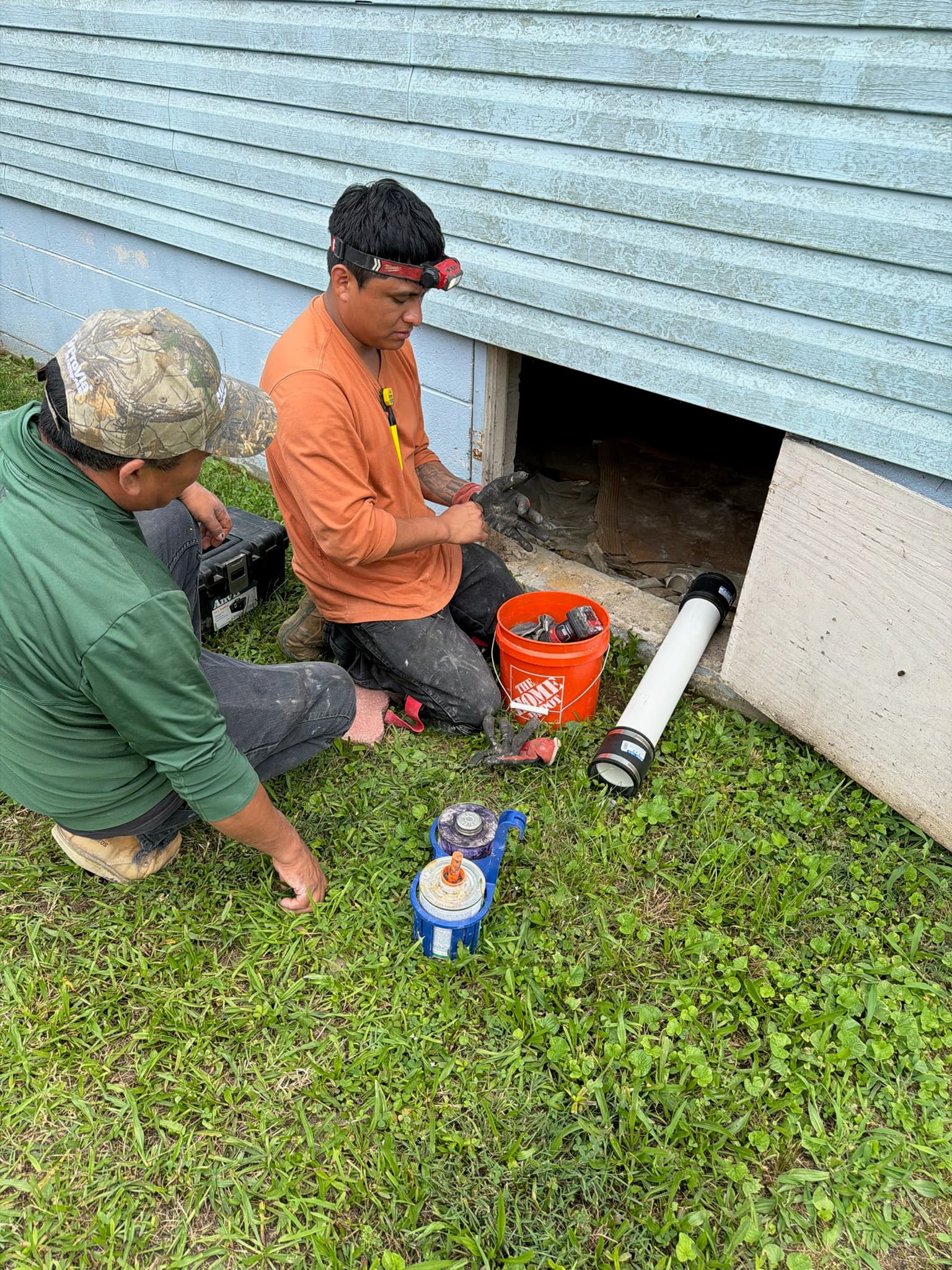 Working on the plumbing from the crawl space